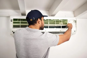 Technician repairing an air conditioning unit